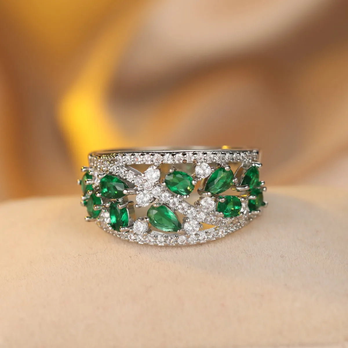 Women's hollow round copper fashion ring with gemstone, shown in gold and platinum colour options.