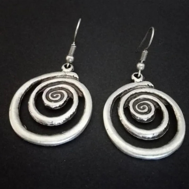 Silver geometric spiral earrings with distressed finish showing 2.6cm width and 5cm length