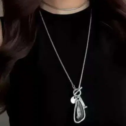 Women's long alloy necklace with geometric pendant and snake bones chain in blue, champagne, or grey.