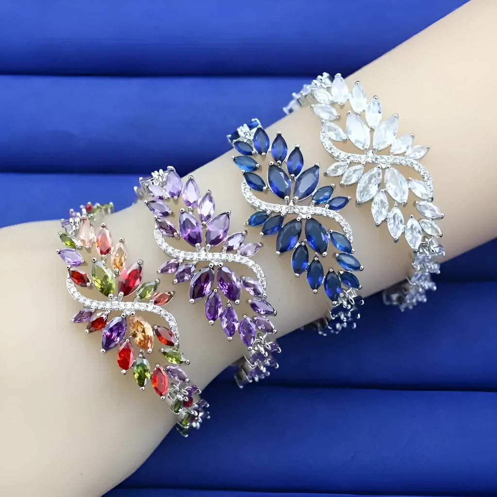 Gold electroplated copper bracelet with ice flower design and blue zircon stones