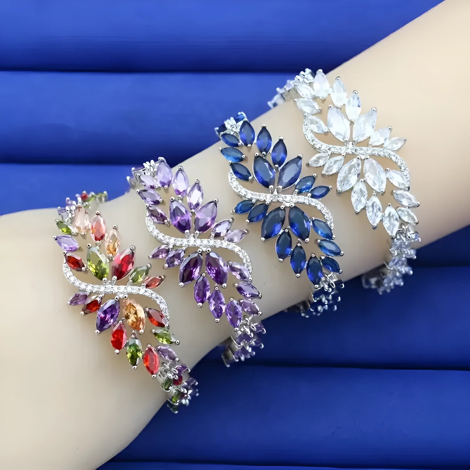 Gold electroplated copper bracelet with ice flower design and blue zircon stones