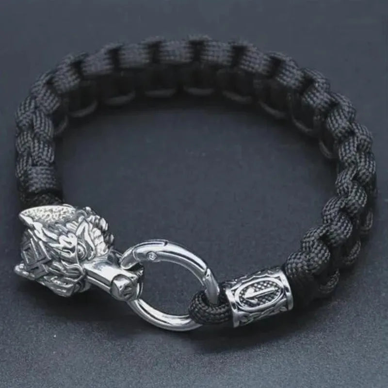 Handmade titanium steel wolf head bracelet in camouflage colour on a wrist.