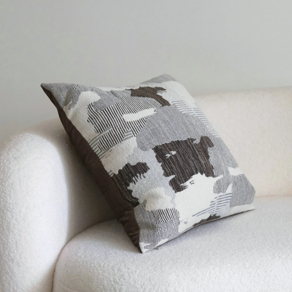 Coffee brown Chinese classical style cushion with striped and patchwork designs on a sofa.