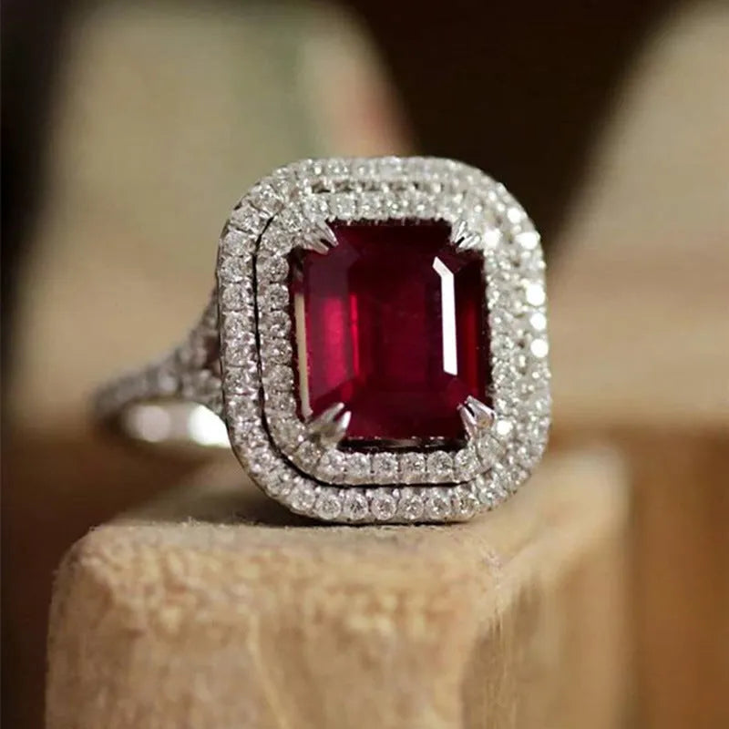 Red copper square women's ring with a central rhinestone on a model's hand.