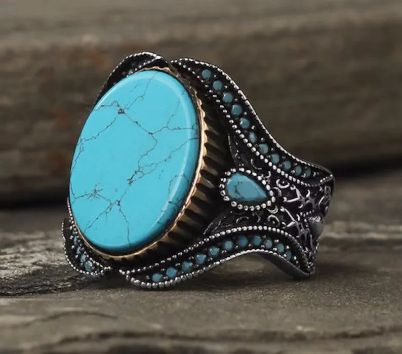 Men's round turquoise ring with antique silver metal band, shown in size 10.