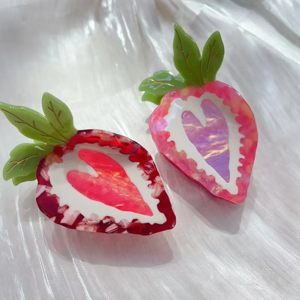 A red or pink hairpin featuring a sweet strawberry fruit design in a pastoral style.