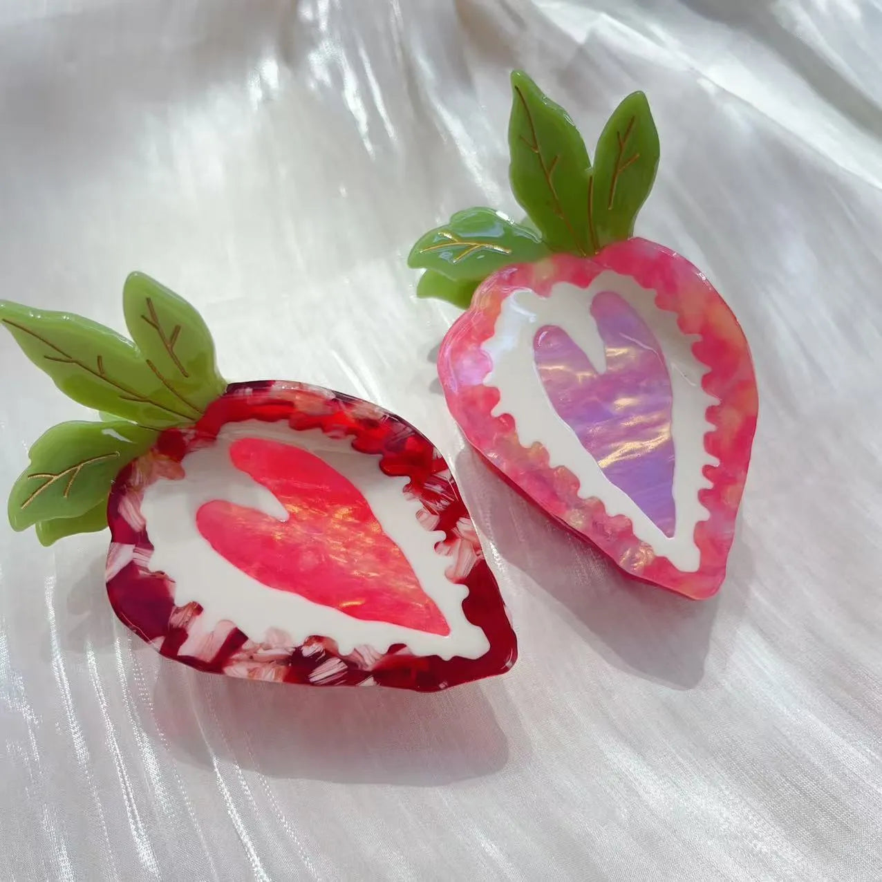 A red or pink hairpin featuring a sweet strawberry fruit design in a pastoral style.