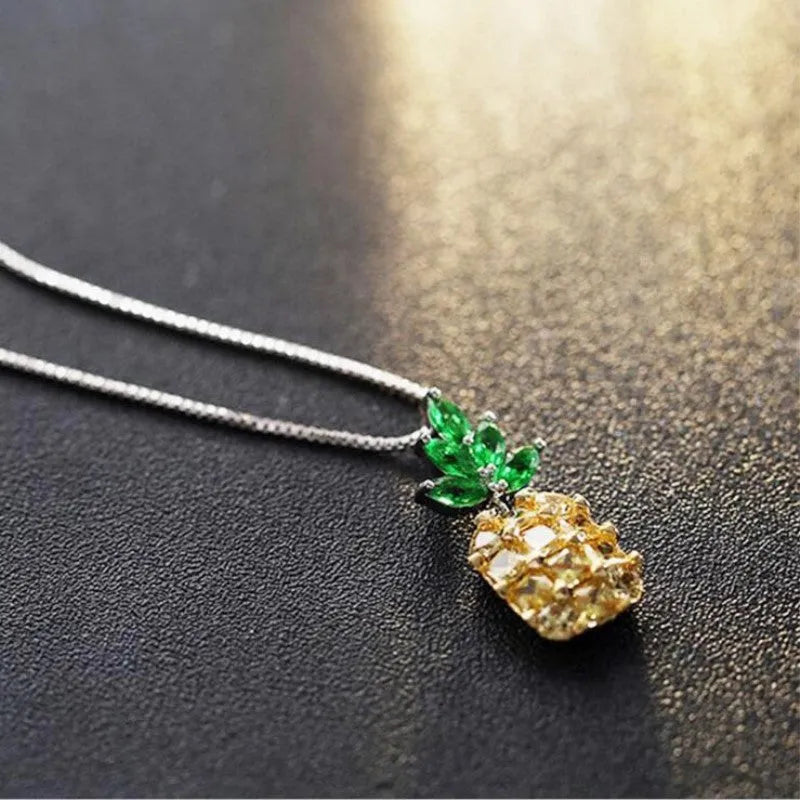 Silver geometric pineapple fruit pendant on a women's fashion necklace.