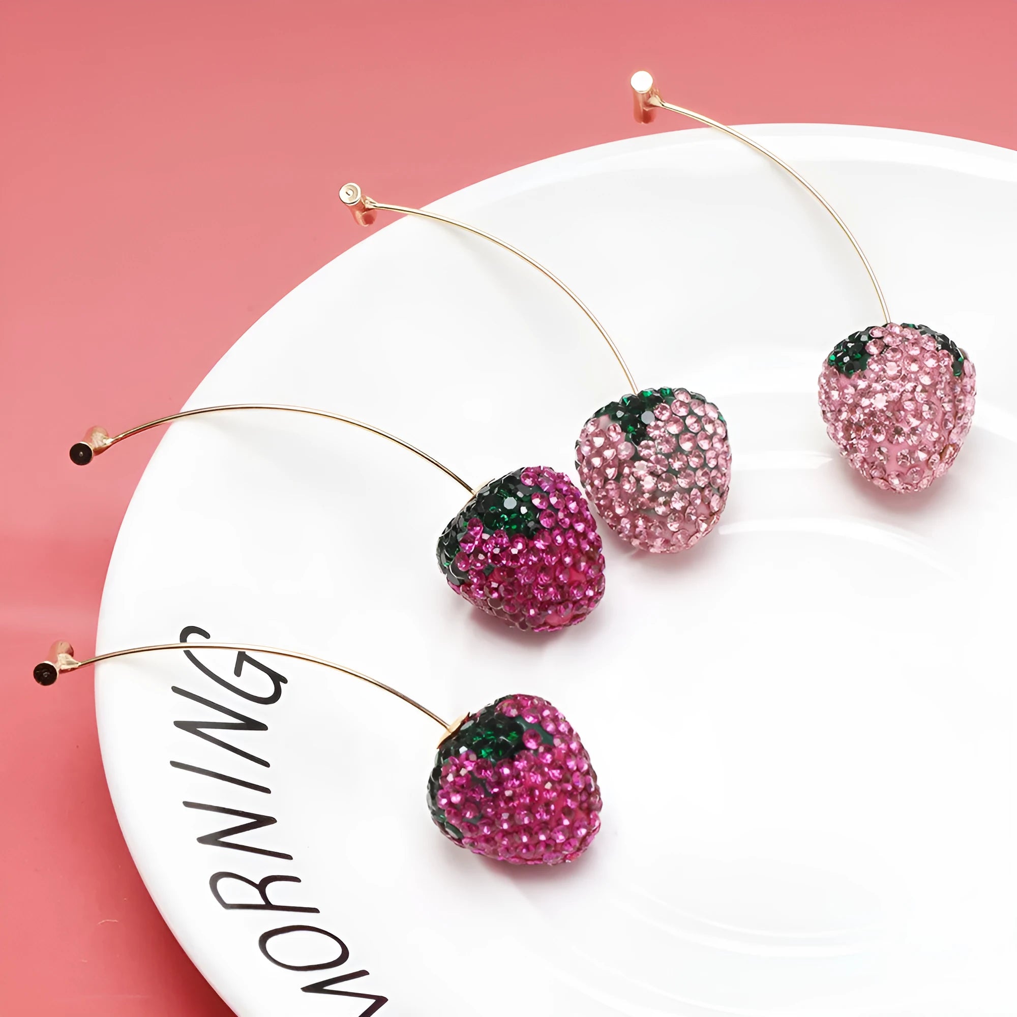 Red zinc alloy strawberry earrings with geometric shape and spot drill texture.