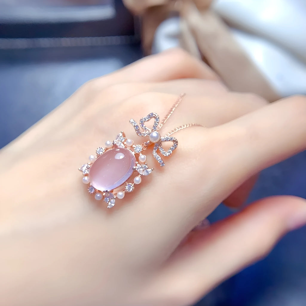 Rose quartz geometric pendant on a silver chain with rose gold plating.