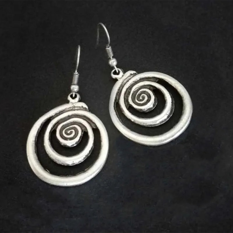 Silver geometric spiral earrings with distressed finish showing 2.6cm width and 5cm length