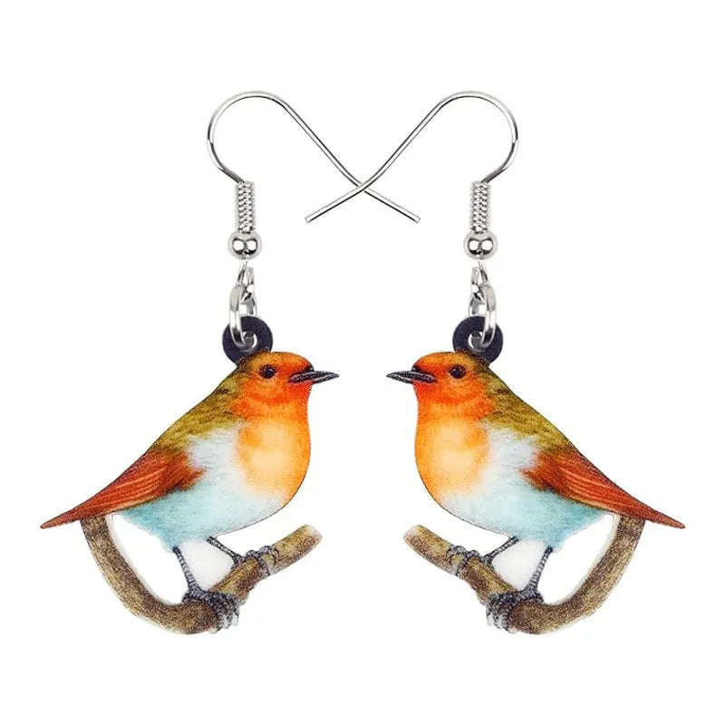 A pair of blue titmouse pendant earrings with printed design on acrylic, featuring geometric and snake elements.