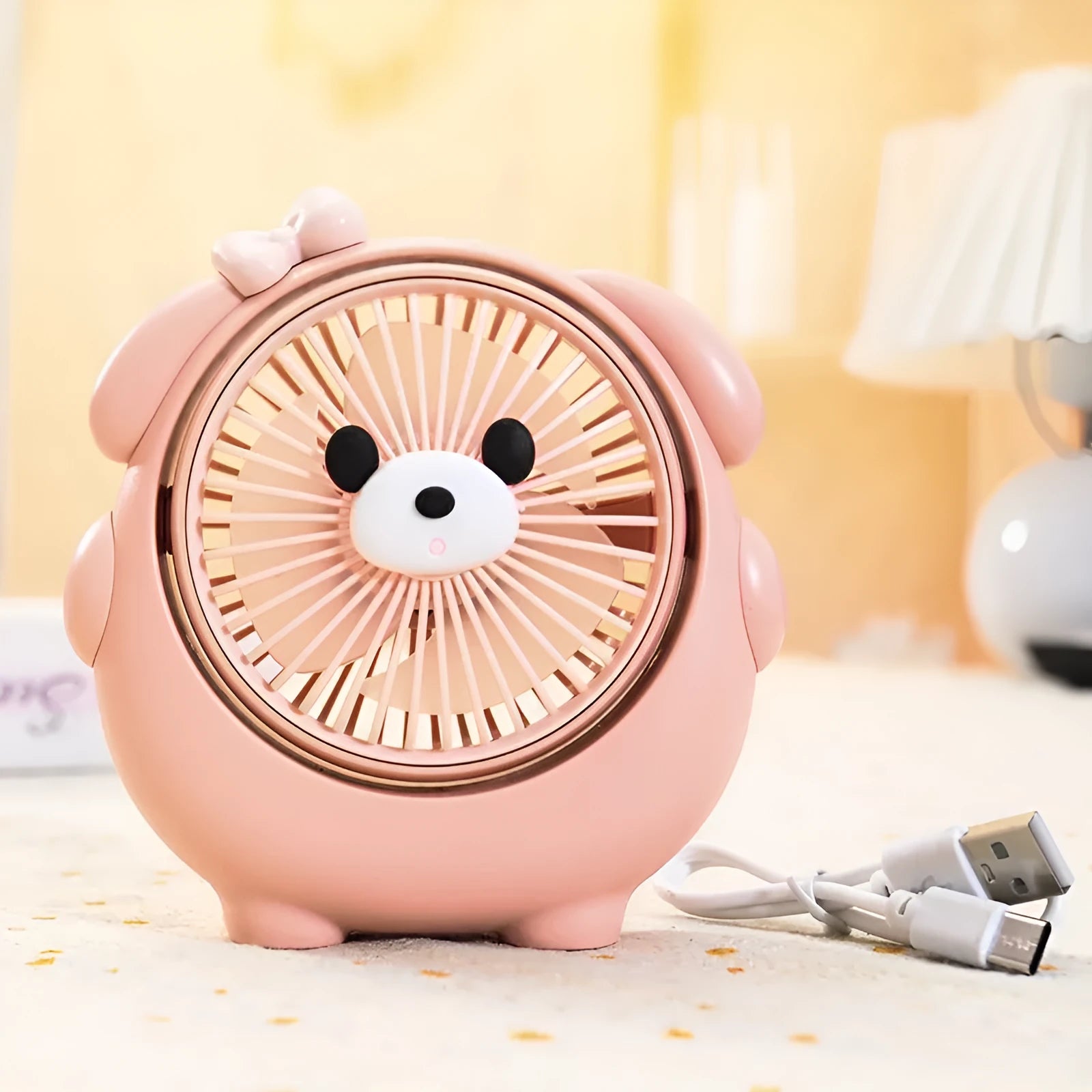 Cute dog-themed USB desktop electric fan on a wooden desk, showing three-speed buttons and a light pink puppy design.