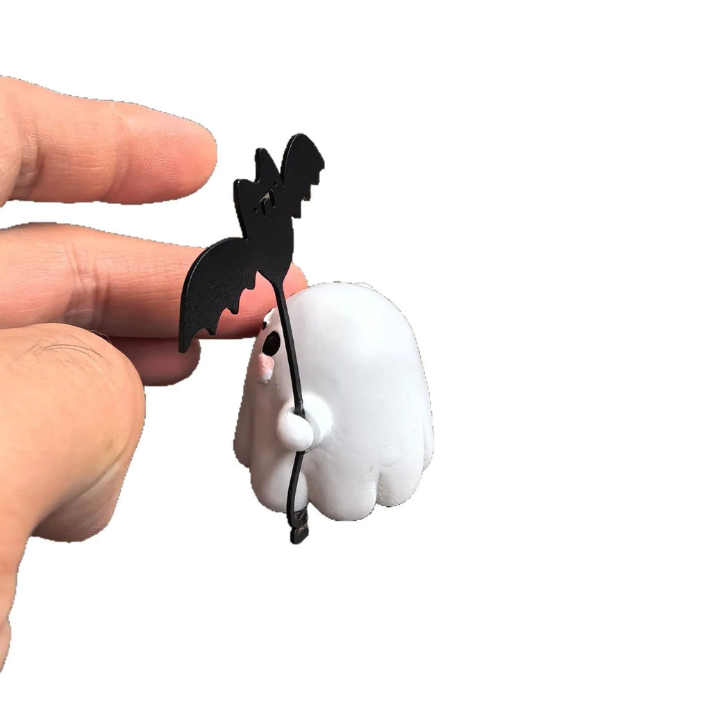 Small resin statue of an American-style ghost walking a dog and holding a bat.