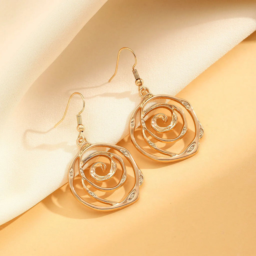 Spiral donut design women's jewellery set showing necklace, bracelet and ear hooks in gold or silver finish