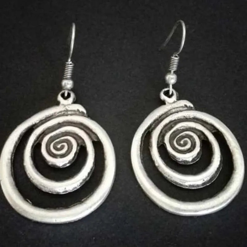 Silver geometric spiral earrings with distressed finish showing 2.6cm width and 5cm length