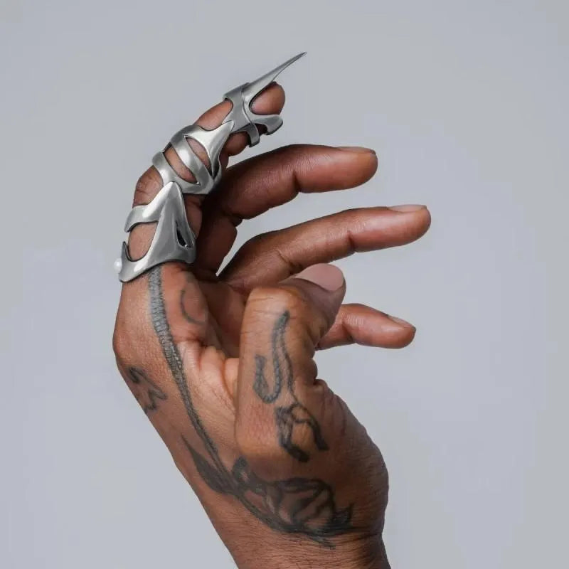 Silver alloy punk armour finger stall ring on a single finger.