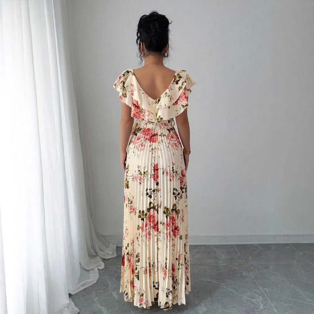 Apricot floral print women's dress with v-neck, ruffled short sleeves, and a high-waisted pleated swing skirt.