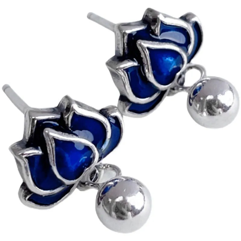 Blue lotus flower ear studs with seedpod tassel detail, silver alloy construction.