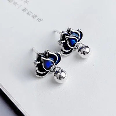Blue lotus flower ear studs with seedpod tassel detail, silver alloy construction.