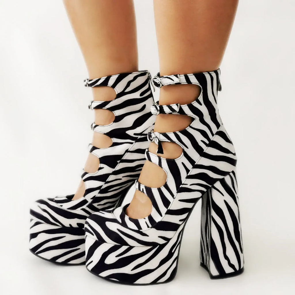 Black patent leather women's platform high heels with a thick heel and a serpentine buckle strap across the foot.