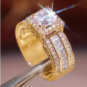 Geometric silver fashion ring for women in gold or white colour on a grey background.