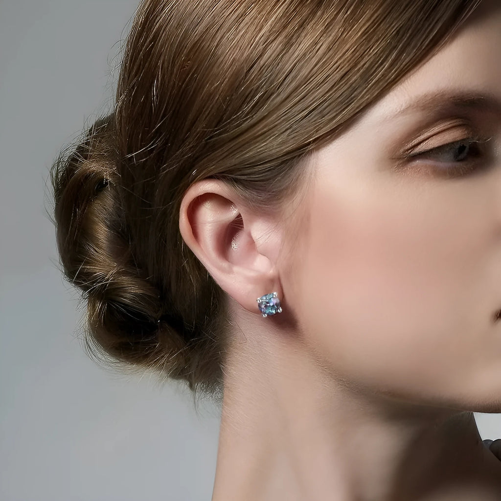 Simple geometric silver ear studs with a round Cultivate Alexandrite stone.