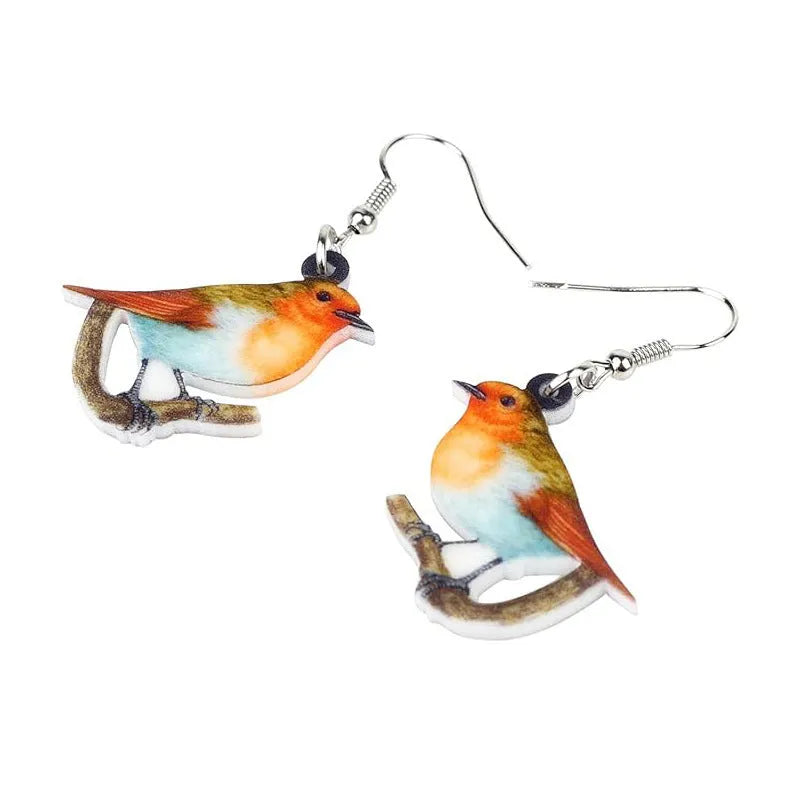 A pair of blue titmouse pendant earrings with printed design on acrylic, featuring geometric and snake elements.