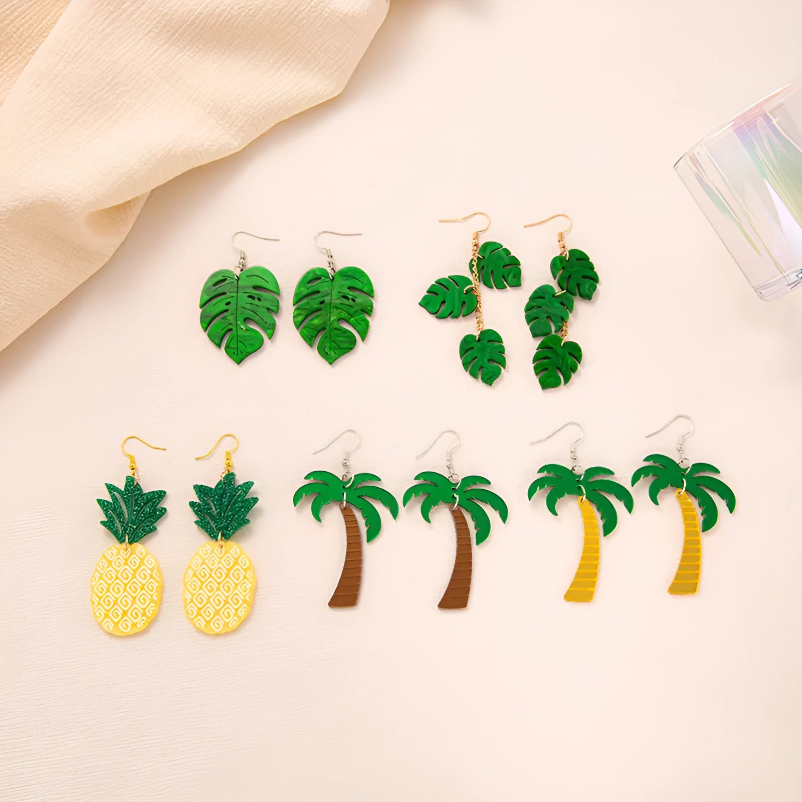 A pair of drop-shaped acrylic earrings designed like coconut leaves, in one of five colour variations.