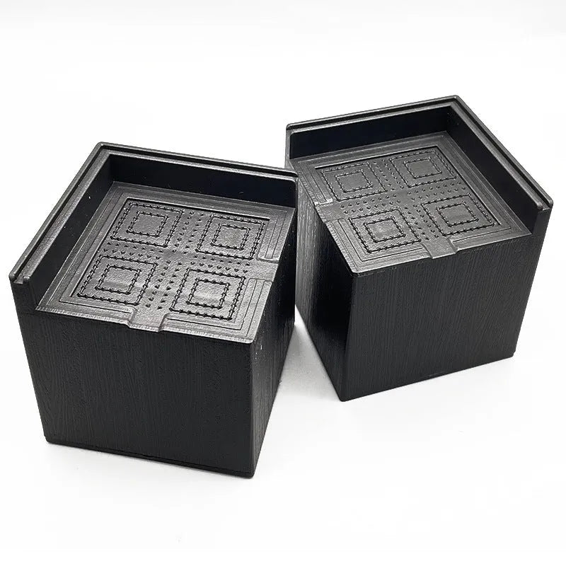 Four black plastic furniture riser mats for bed and sofa feet height adjustment