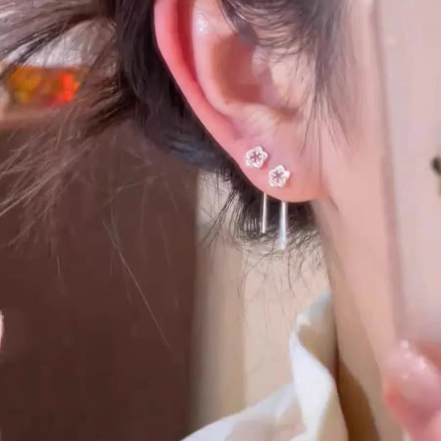 Silver hollow flower hanging earrings with petal design on alloy studs