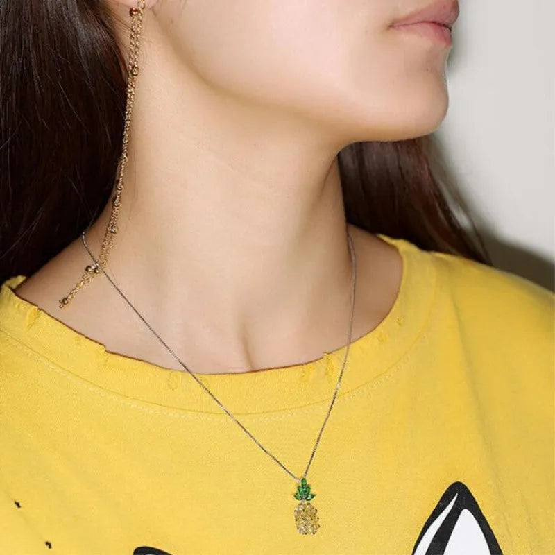 Silver geometric pineapple fruit pendant on a women's fashion necklace.