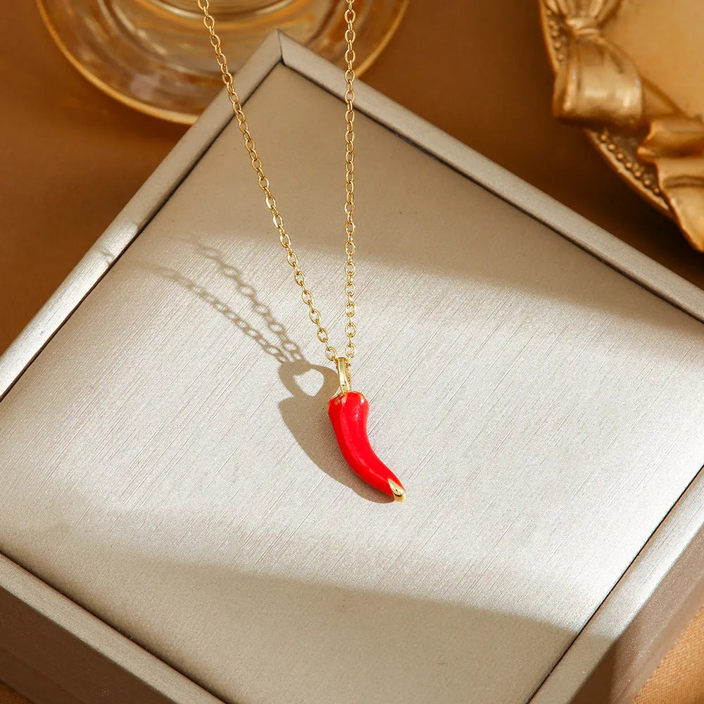 Close-up of a titanium steel necklace with an indie-style cherry pendant on an O-ring chain.