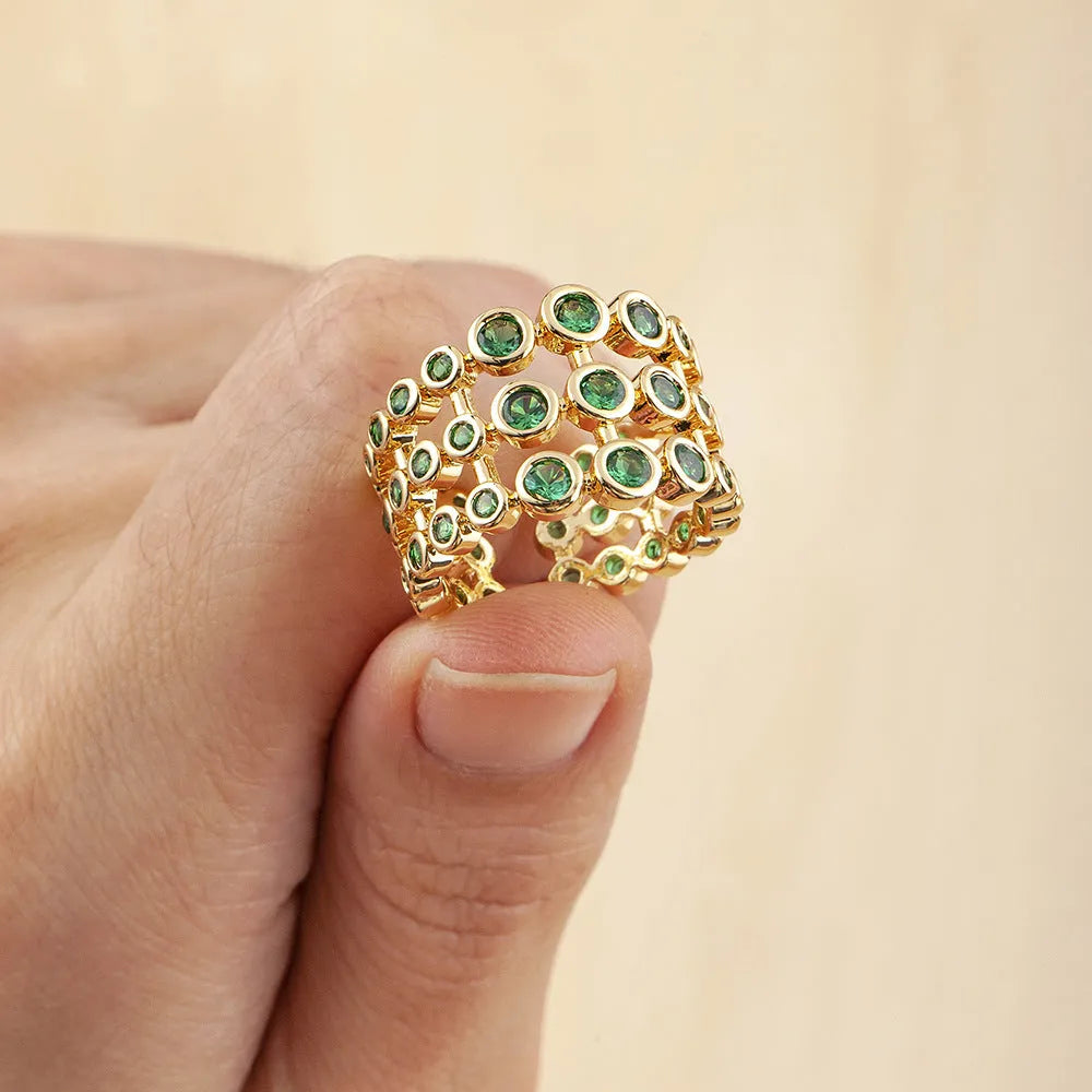 Wide copper ring with layered gold plating and green zircon stones