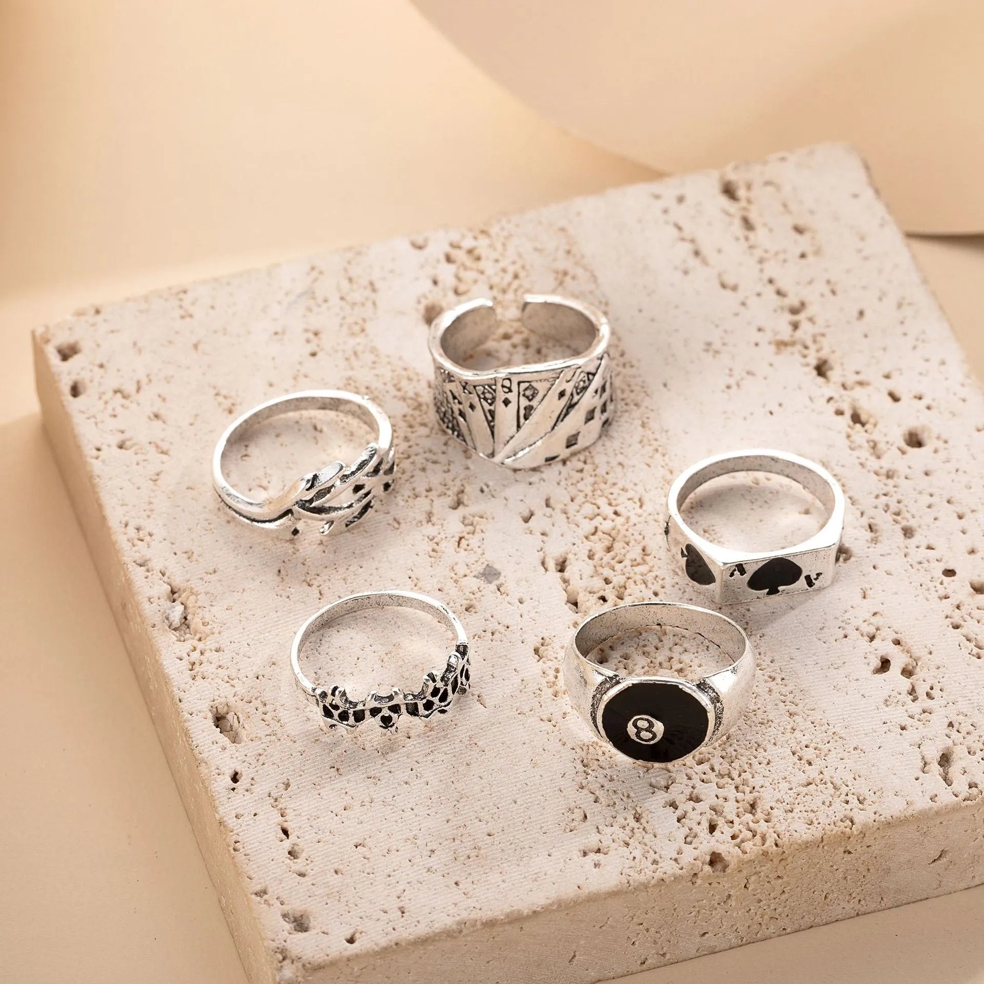 Black alloy poker ring with a retro spade card design on a finger.