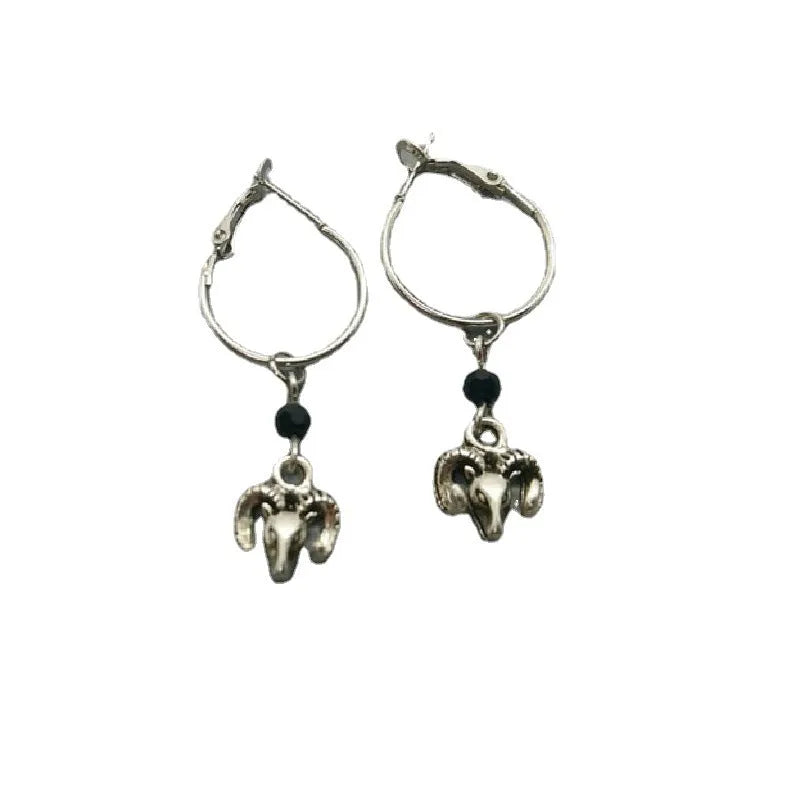 A pair of silver-coloured alloy round ring earrings featuring a Tibetan antelope design.