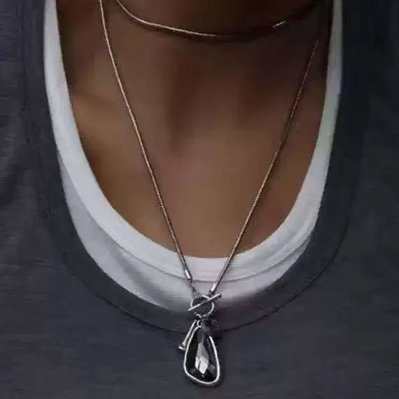 Women's long alloy necklace with geometric pendant and snake bones chain in blue, champagne, or grey.