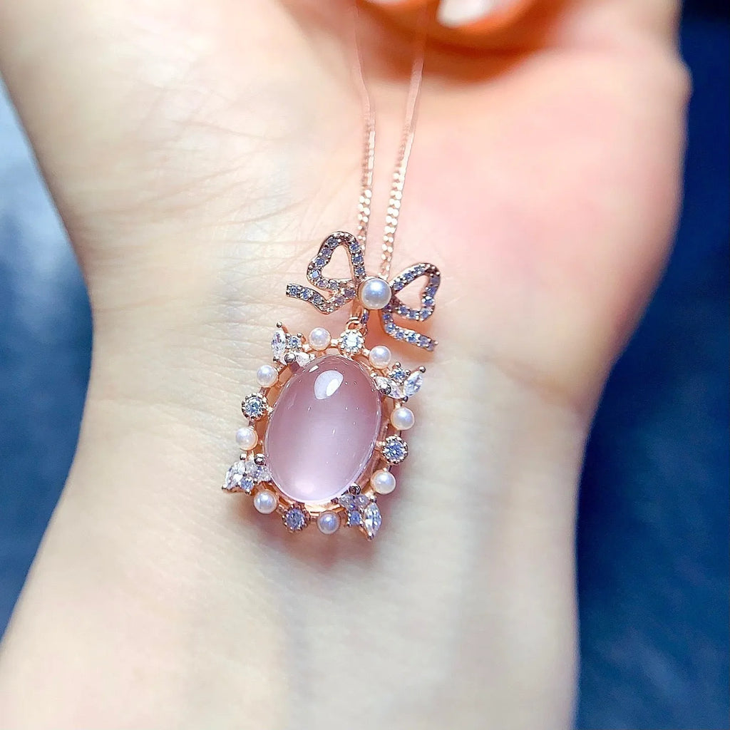 Rose quartz geometric pendant on a silver chain with rose gold plating.