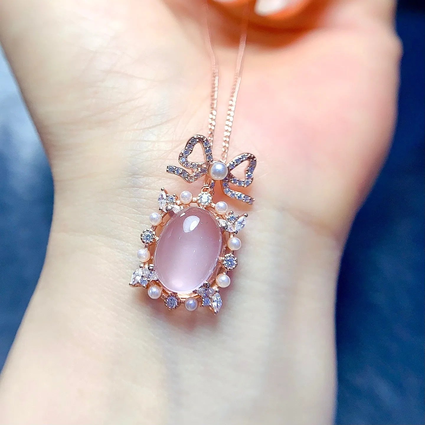 Rose quartz geometric pendant on a silver chain with rose gold plating.