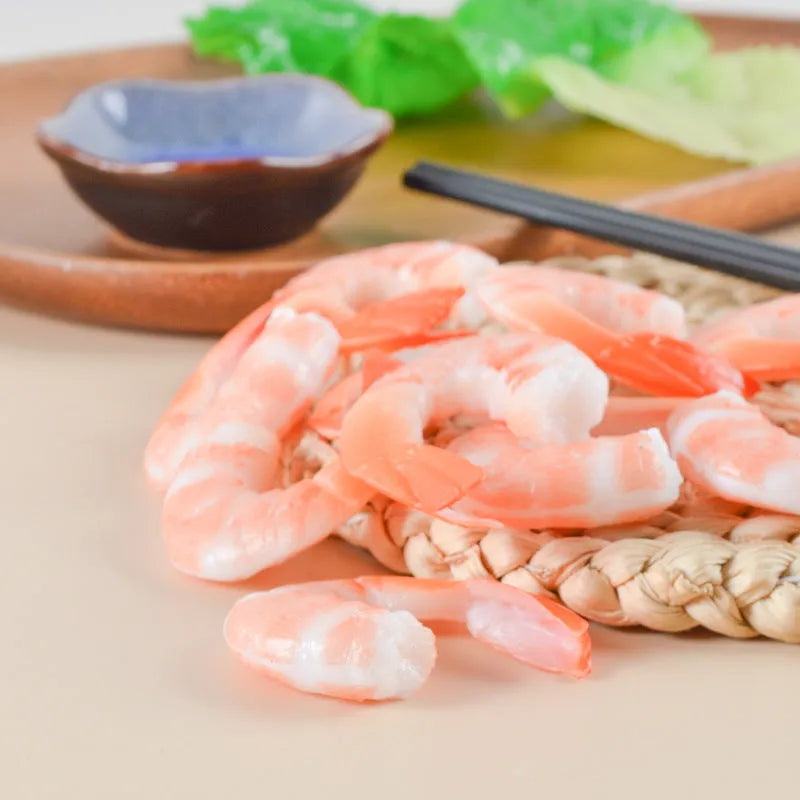 PVC shrimp-shaped keychain with metal door buckle, showing detailed crustacean design.