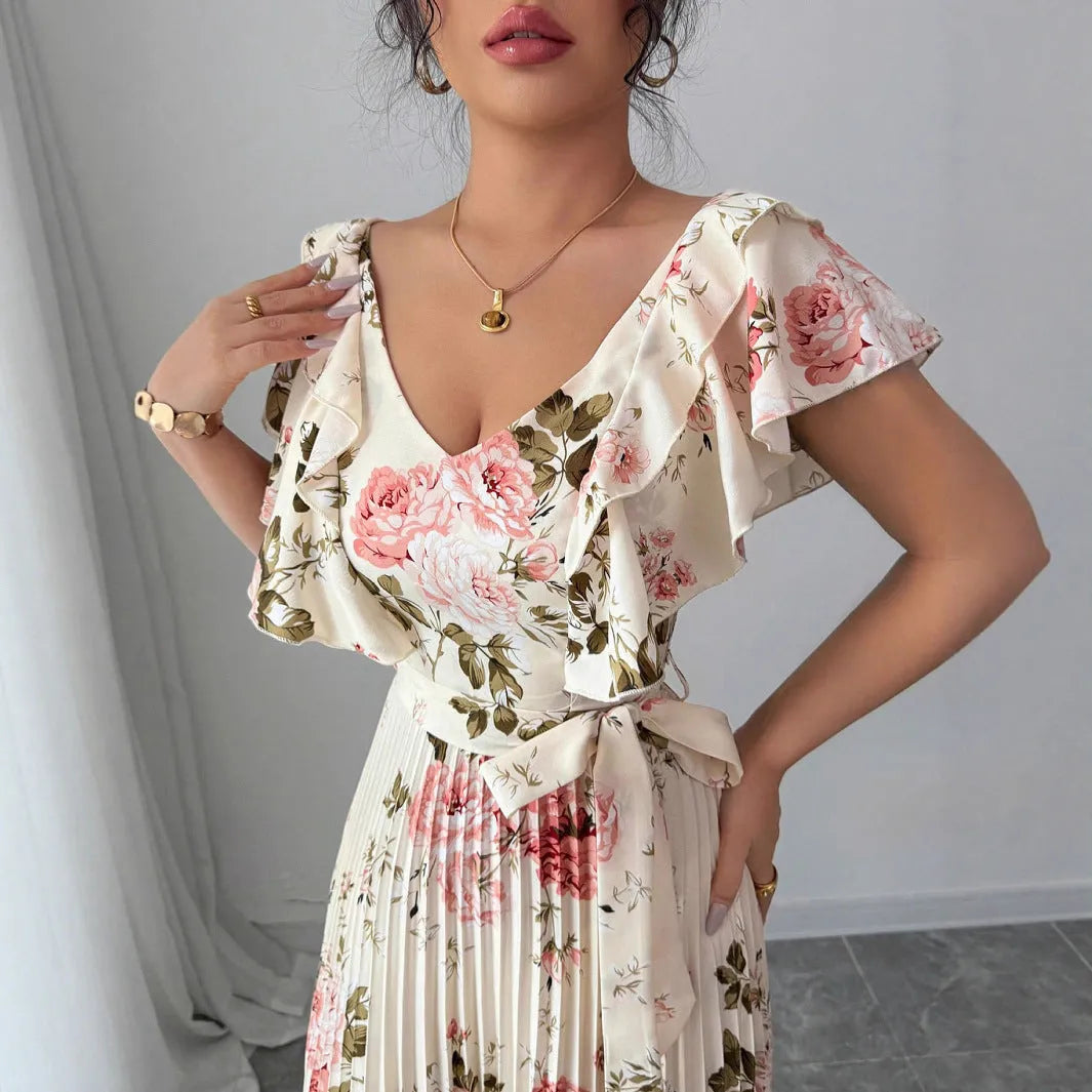 Apricot floral print women's dress with v-neck, ruffled short sleeves, and a high-waisted pleated swing skirt.