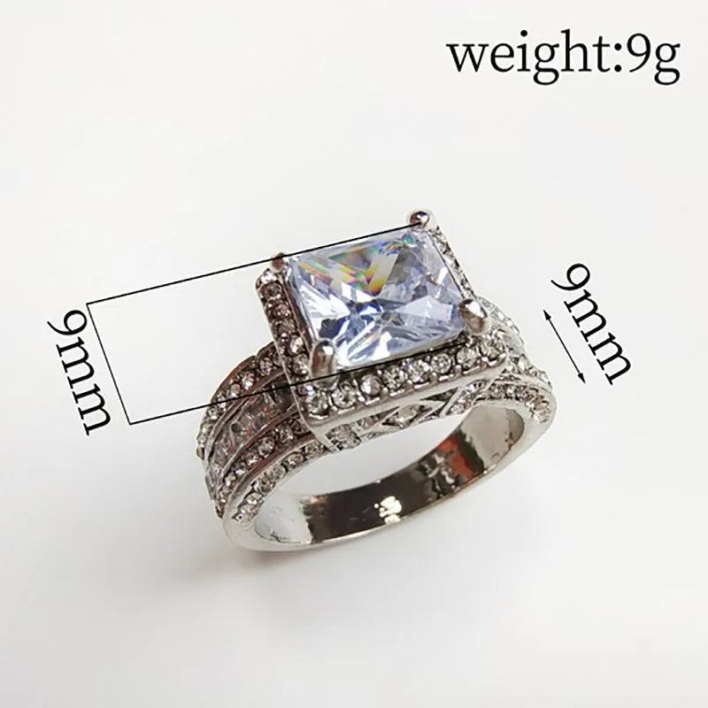Geometric silver fashion ring for women in gold or white colour on a grey background.