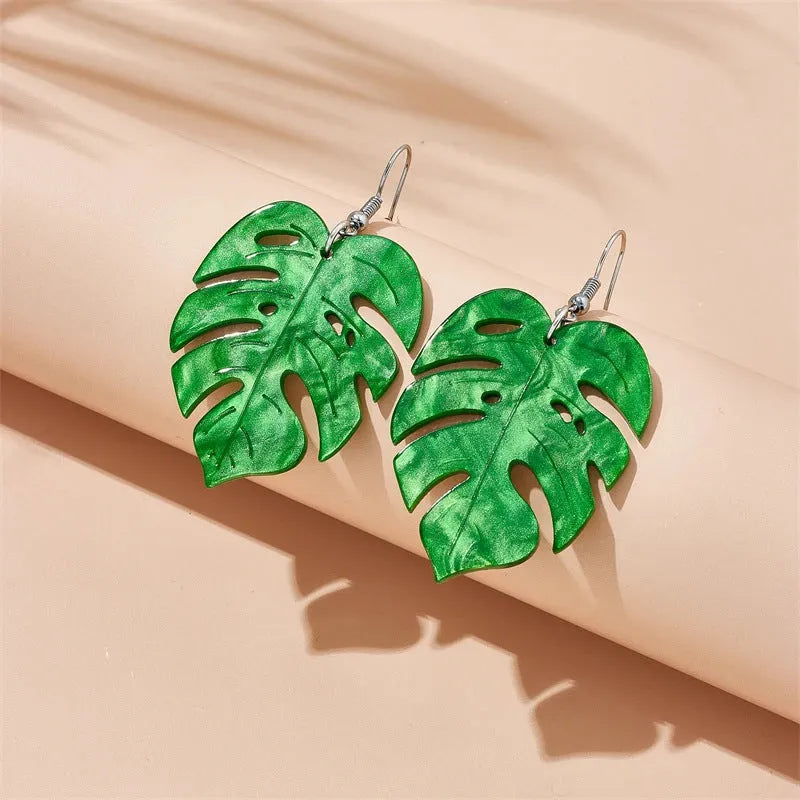 A pair of drop-shaped acrylic earrings designed like coconut leaves, in one of five colour variations.