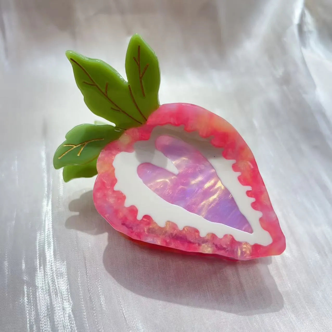 A red or pink hairpin featuring a sweet strawberry fruit design in a pastoral style.