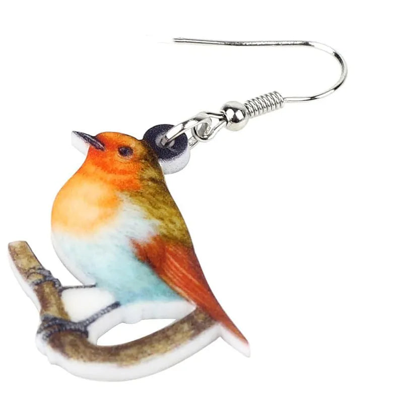 A pair of blue titmouse pendant earrings with printed design on acrylic, featuring geometric and snake elements.