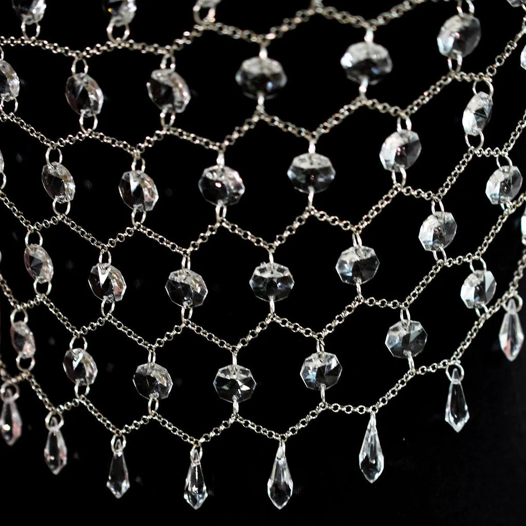 Hand-woven transparent acrylic sequinned plastic resin body chain draped flat.