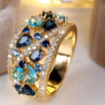 Women's hollow round copper fashion ring with gemstone, shown in gold and platinum colour options.