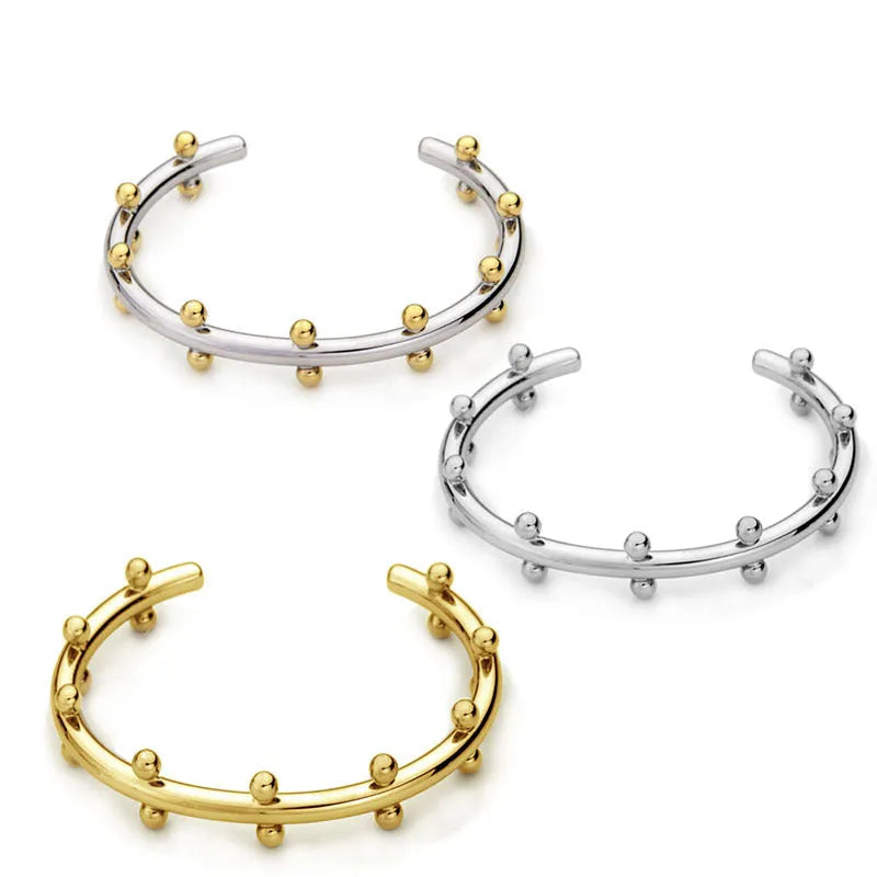 Stainless steel C-shaped ring with textured rivet bean beads and alloy bracelet in gold finish