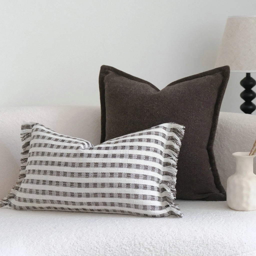 Coffee brown Chinese classical style cushion with striped and patchwork designs on a sofa.