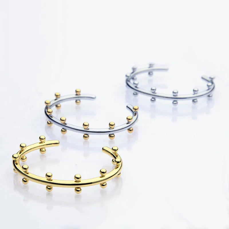 Stainless steel C-shaped ring with textured rivet bean beads and alloy bracelet in gold finish